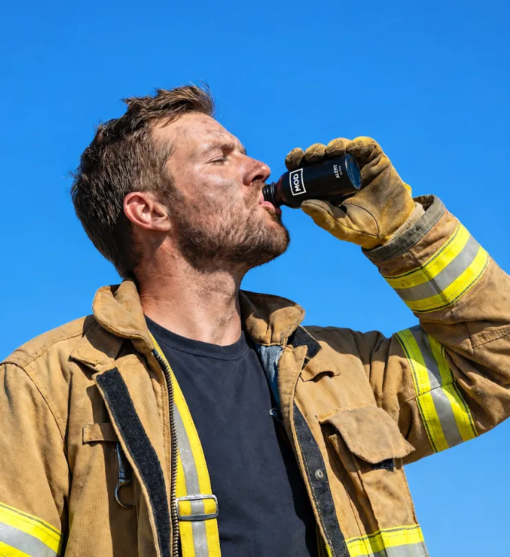 Firefighter drinking MOD alert with blue sky background
